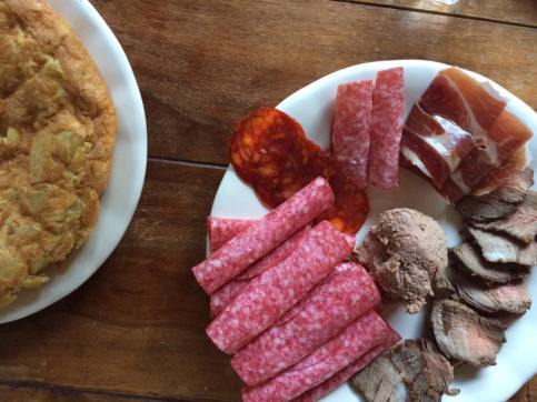A spanish tortilla with turkey paté and cured meats